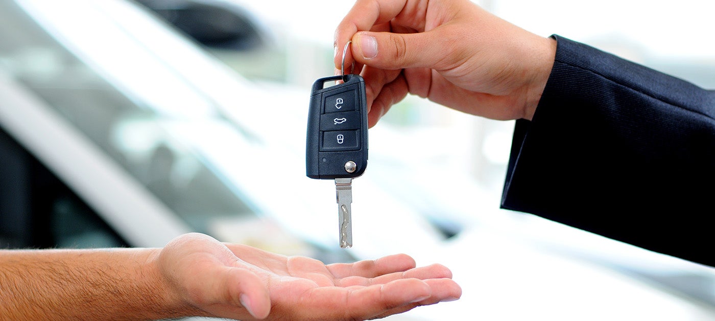 salesman passing car key